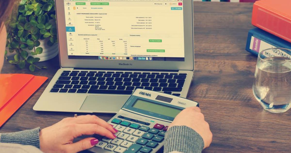 A calculator and financial paperwork on a desk