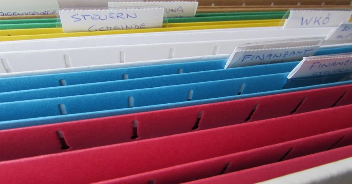 Colored hanging file folders in a drawer