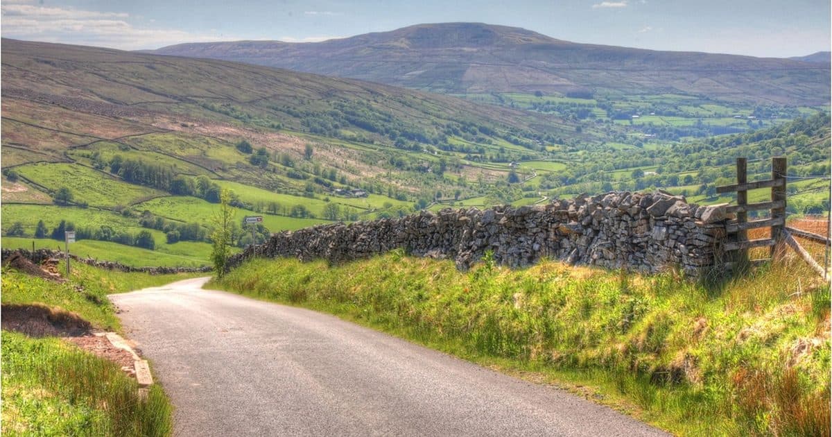 A country road winding through green hills