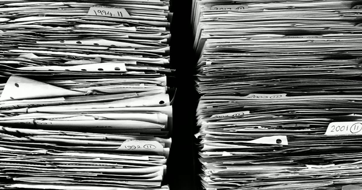 Stacks of paper files and document folders