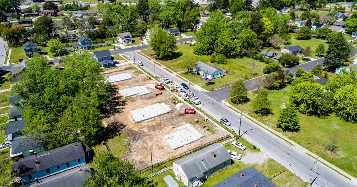 Aerial view of a suburban neighbourhood with new house foundations